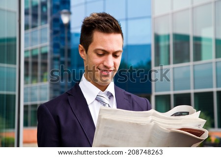 Business man reading a newspaper