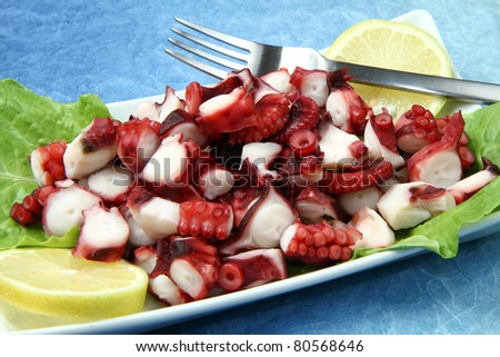 octopus salad with lemon slice and lettuce