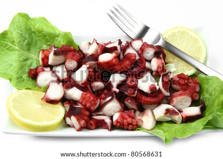 octopus salad with lemon slice and lettuce