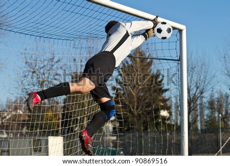 Soccer football goalkeeper making diving save