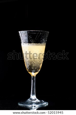 A sparkling wine glass with sparkling wine isolated on a black background