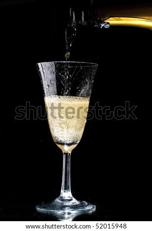 A sparkling wine glass with sparkling wine isolated on a black background