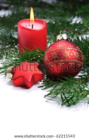 A christmas bauble, a christmas star and a candle isolated on a white background