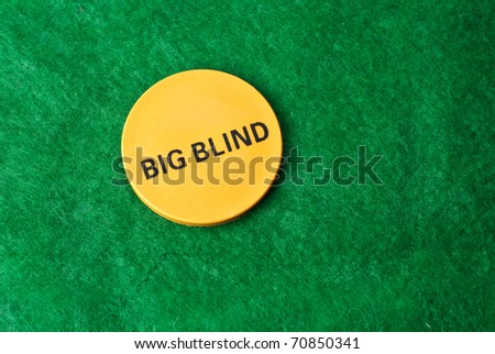 Poker Big Blind Button isolated against green felt