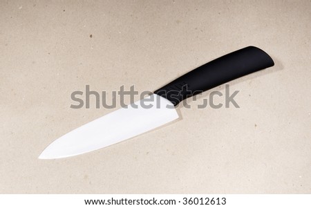 White ceramic knife on draft paper background