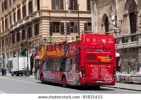 PALERMO, ITALY - MAY 2: Tourist bus on street of Palermo on May 2, 2011. Crowds of tourists visit Palermo - a historic city in Southern Italy, the capital of Sicily and the Province of Palermo.