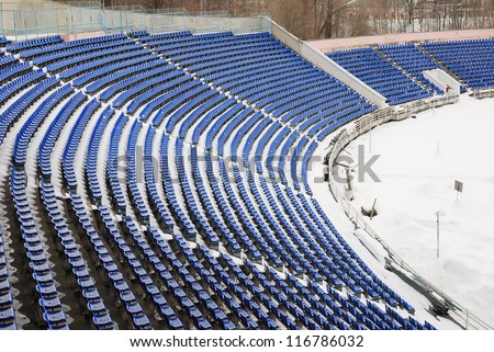 part of a snow-covered stadium, football ground in winter