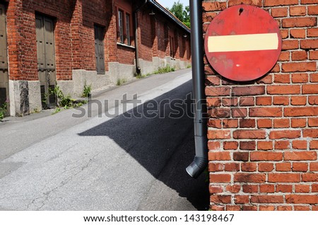 no entry road sign on a brick wall