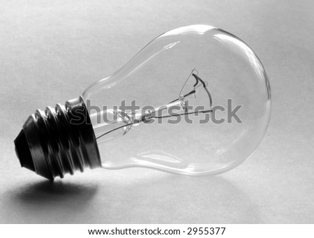 electric light bulb on the light-grey surface