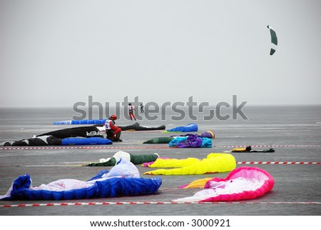 at the starting line: bright kites in the grey foggy lake Onego