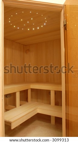 little cozy modern sauna of light wood nicely illuminated