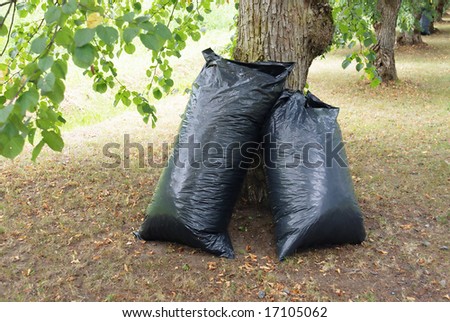 big black refue bags full of gathered waste in the park