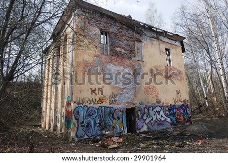 old blasted house in park with graffiti