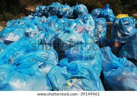 blue plastic garbage bags full of trash