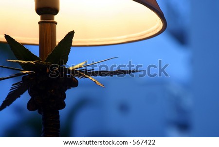 A lamp with a dim light and a blue background.