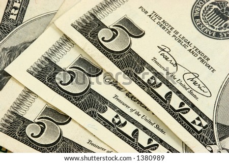 Stack of five dollars bills closeup