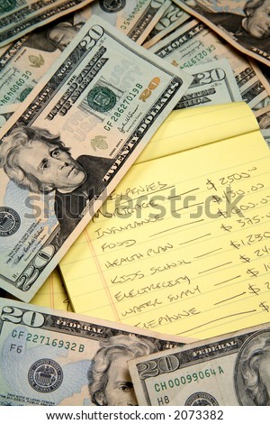Lots of cash, twenty dollar bills, disperse over a table top drowning a budget list.