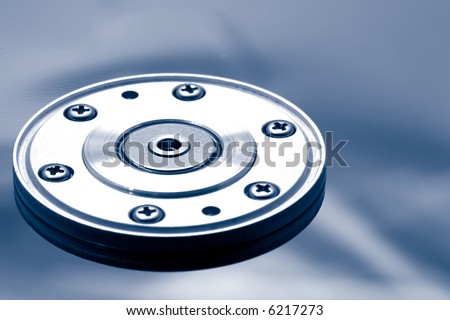 Hard disk drive silver shiny surface and rotor mechanism shown open.