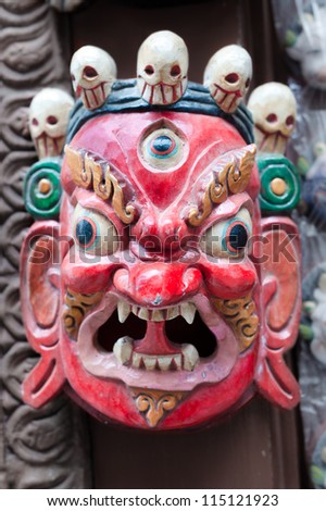Colorful Buddhist mask on a temple wall