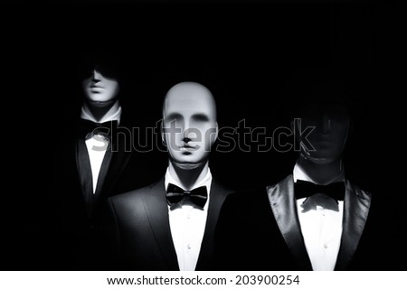 fashion showcase men models in black dress suit isolated on black background