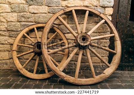 rustic wagon wheels in front of the wall in old city Baku, Azerbaijan