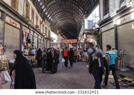 DAMASCUS, SYRIA - NOVEMBER 16, 2012: Ordinary day at Al-Hamidiyah Souq in the old city of Damascus. Bazaar is the largest souk in Syria.The souq starts at Al-Thawra street and ends at Umayyad Mosque.