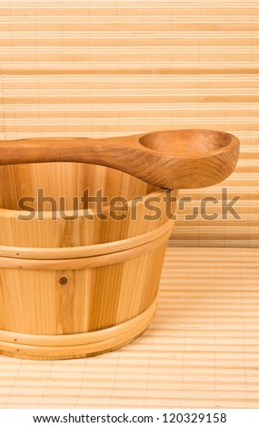 Wooden bucket and spoon in sauna