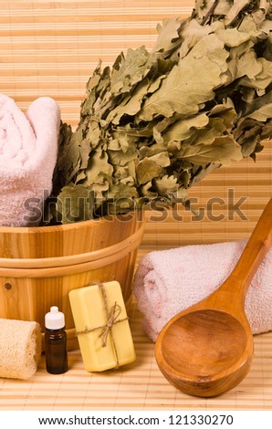 Wooden bucket with sauna accessories and toiletries