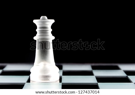Queen chess piece on chess board