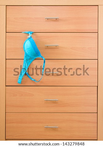 Blue bra in wooden dresser
