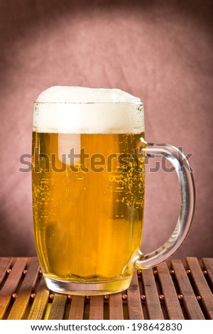 Golden foamy light beer in mug