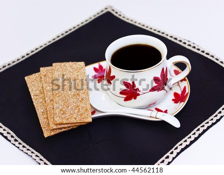 Cup of coffee and bred slices on napkin