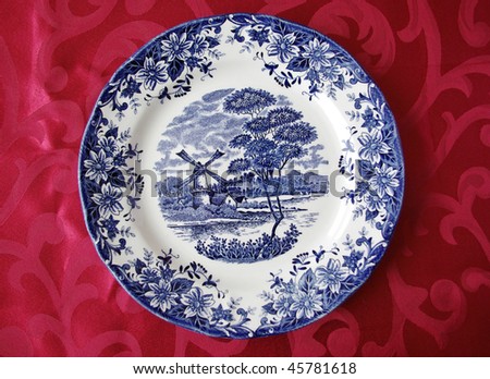 Blue plate on red tablecloth