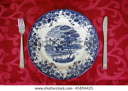 Table setting with empty plate, knife and fork. See more my cutlery photos: http://www.shutterstock.com/sets/65705-cutlery.html?rid=522649