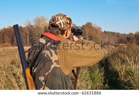 Hunter aiming moose with rifle. See more my hunting related photos: http://www.shutterstock.com/sets/46993-hunting.html?rid=522649