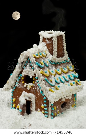 Gingerbread house at night with moon on sky