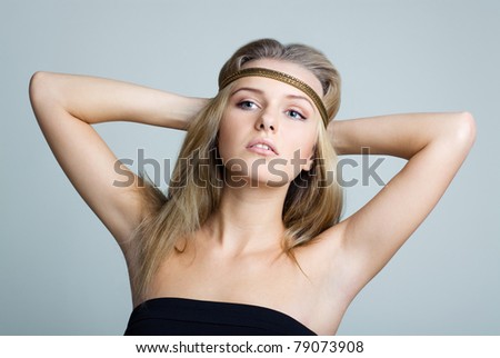 BEAUTIFUL WOMAN WITH GOLD JEWELRY BAND. Her hands behind head showing the armpits.