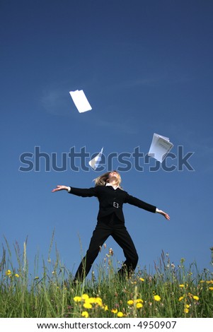 Woman throwing office papers in the air.