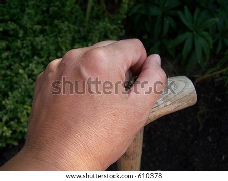 hand on spade resting
