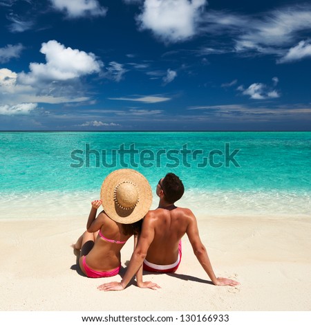 Couple on a tropical beach at Maldives Couple on a tropical beach at Maldives