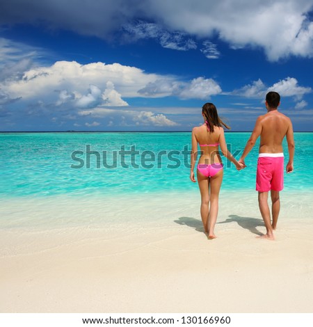 Couple on a tropical beach at Maldives Couple on a tropical beach at Maldives