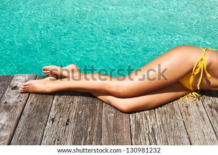 Woman\'S Legs At Beach Jetty