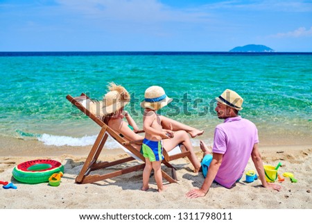 Family on beach, young couple with three year old boy. Summer family vacation. Sithonia, Greece.