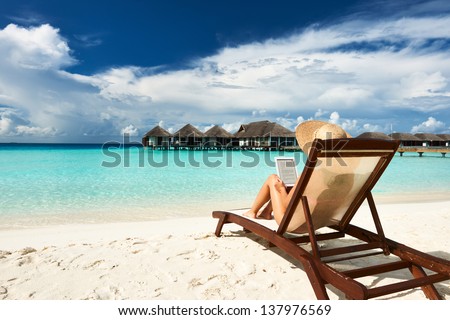 Young Woman In Hat With Tablet Pc At The Beach