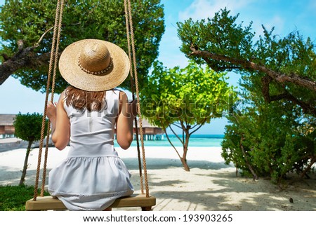 Woman in white dress at tropical beach