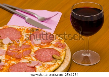 Pizza with salami & glass of wine
