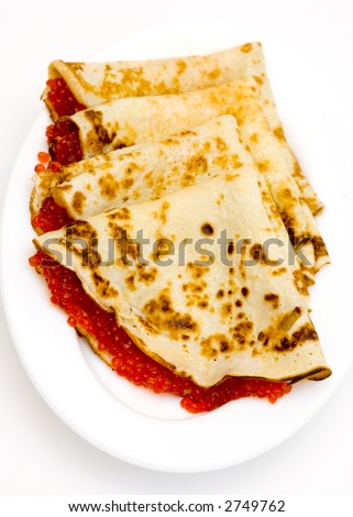 Pancakes with red caviar on a plate (Traditional russian dish)