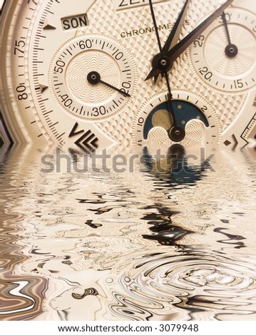 Swiss watch close up with reflection on water