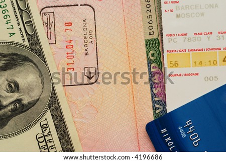 Boarding pass, entry stamps & visa in passport page, money, credit card