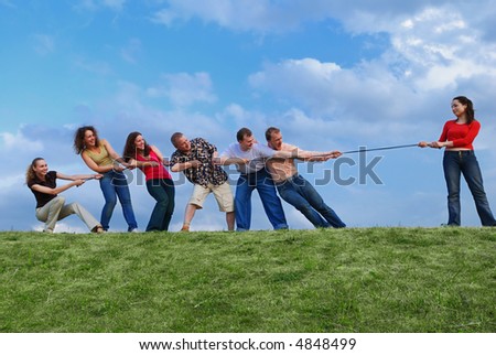 Group of happy people pulling the rope